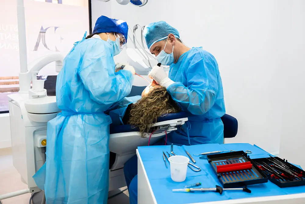 Two clinicians placing an implant on a live patient at the Aranjuez centre